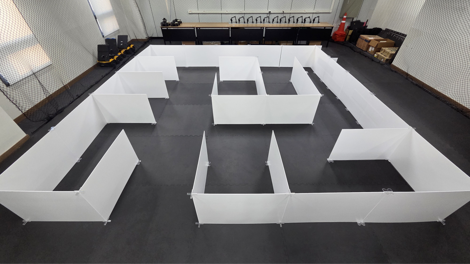 Physical maze testbed with white corridor partitions used for TurtleBot3 navigation